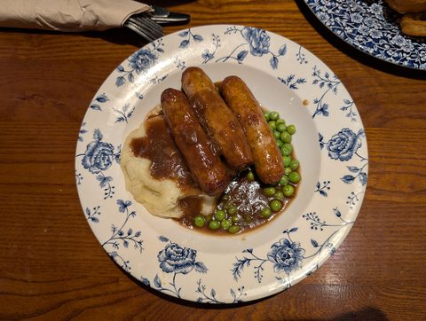 Representative photograph of Bangers and Mash. The photograph includes peas not included in this recipe.