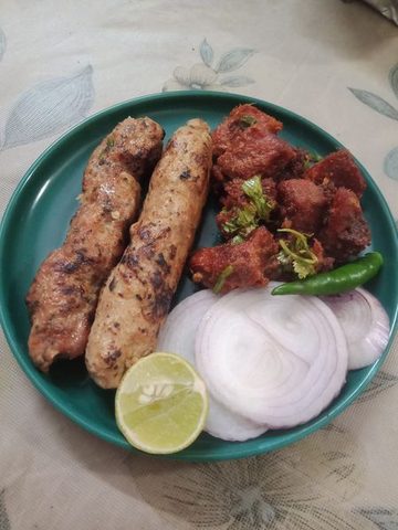 Representative photograph of Beef Seekh Kebab. The photograph includes beef boti kebab beside the seekh kebab; this recipe makes seekh kebabs only.