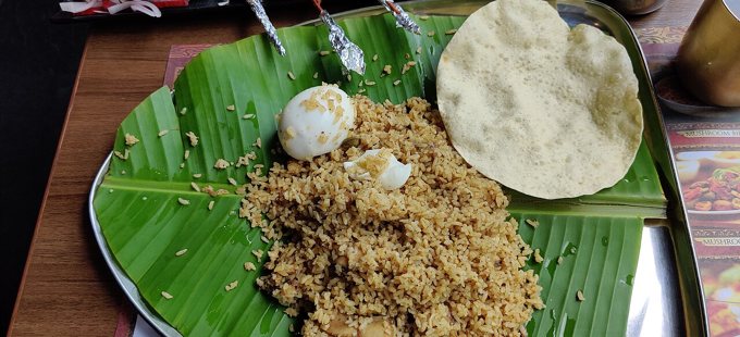 Dindigul Thalappakatti biryani with side dishes, photographed by the credited contributor.