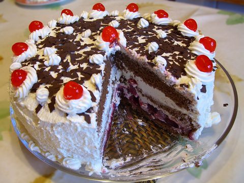 Representative photograph of Black Forest Cake. The photograph includes decorative cherries on top; this recipe uses cherries in the filling.