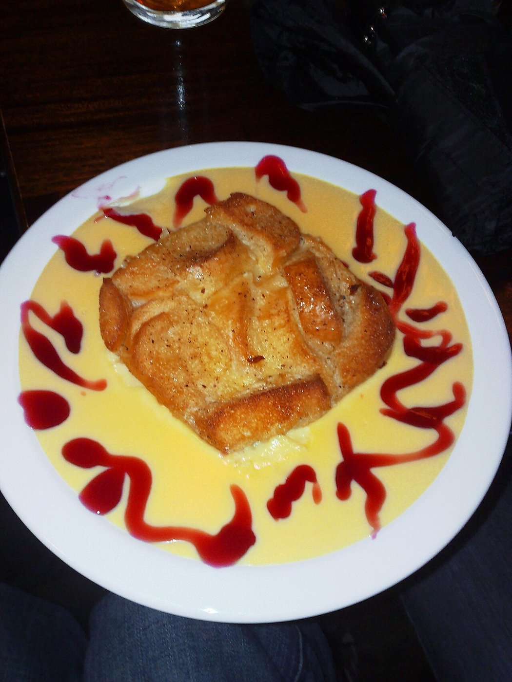 Representative photograph of Bread and Butter Pudding. The photograph includes custard and fruit sauce not included in this recipe.