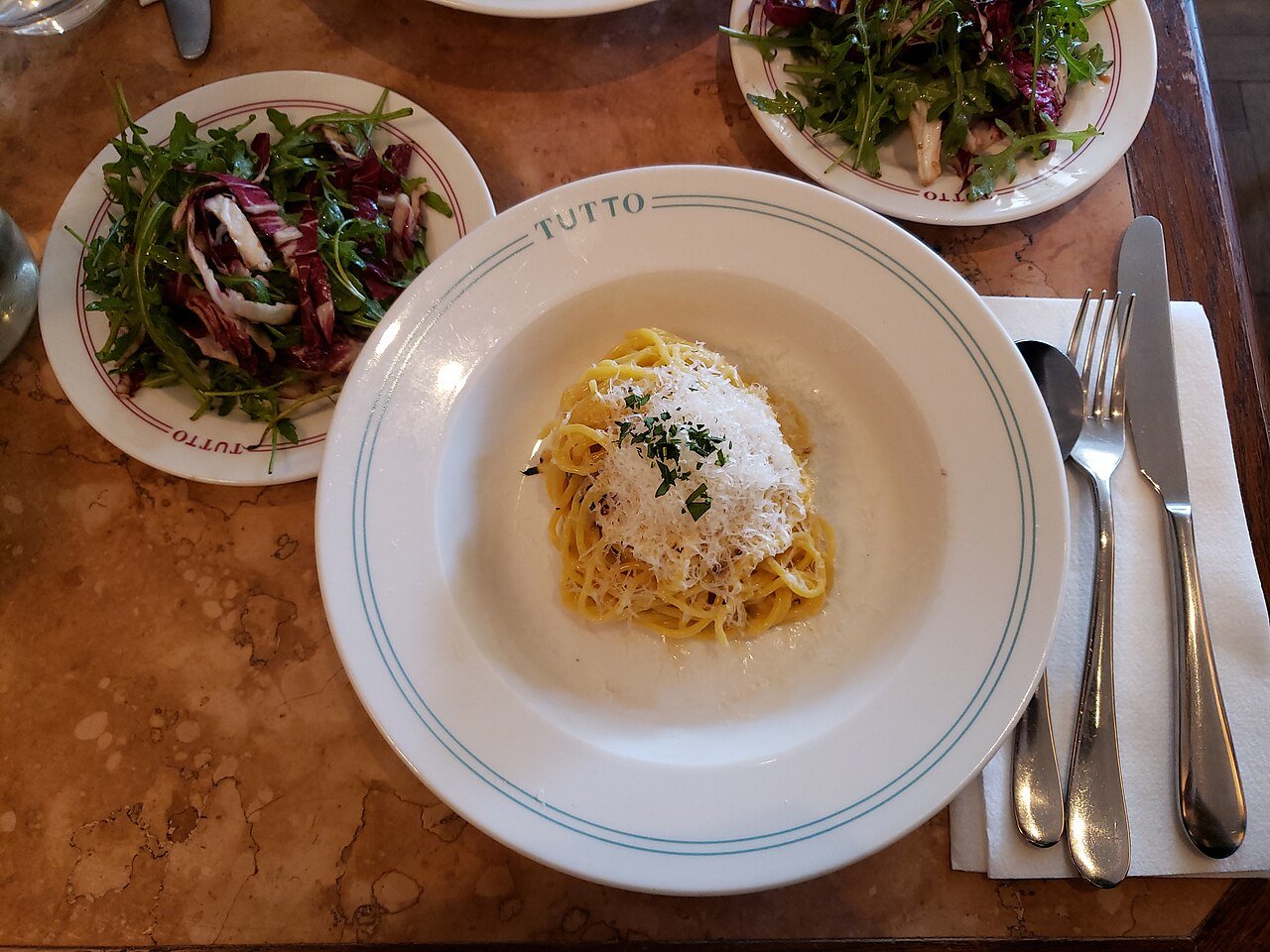 Representative photograph of Cacio e Pepe. The photograph includes a side salad not included in this recipe.