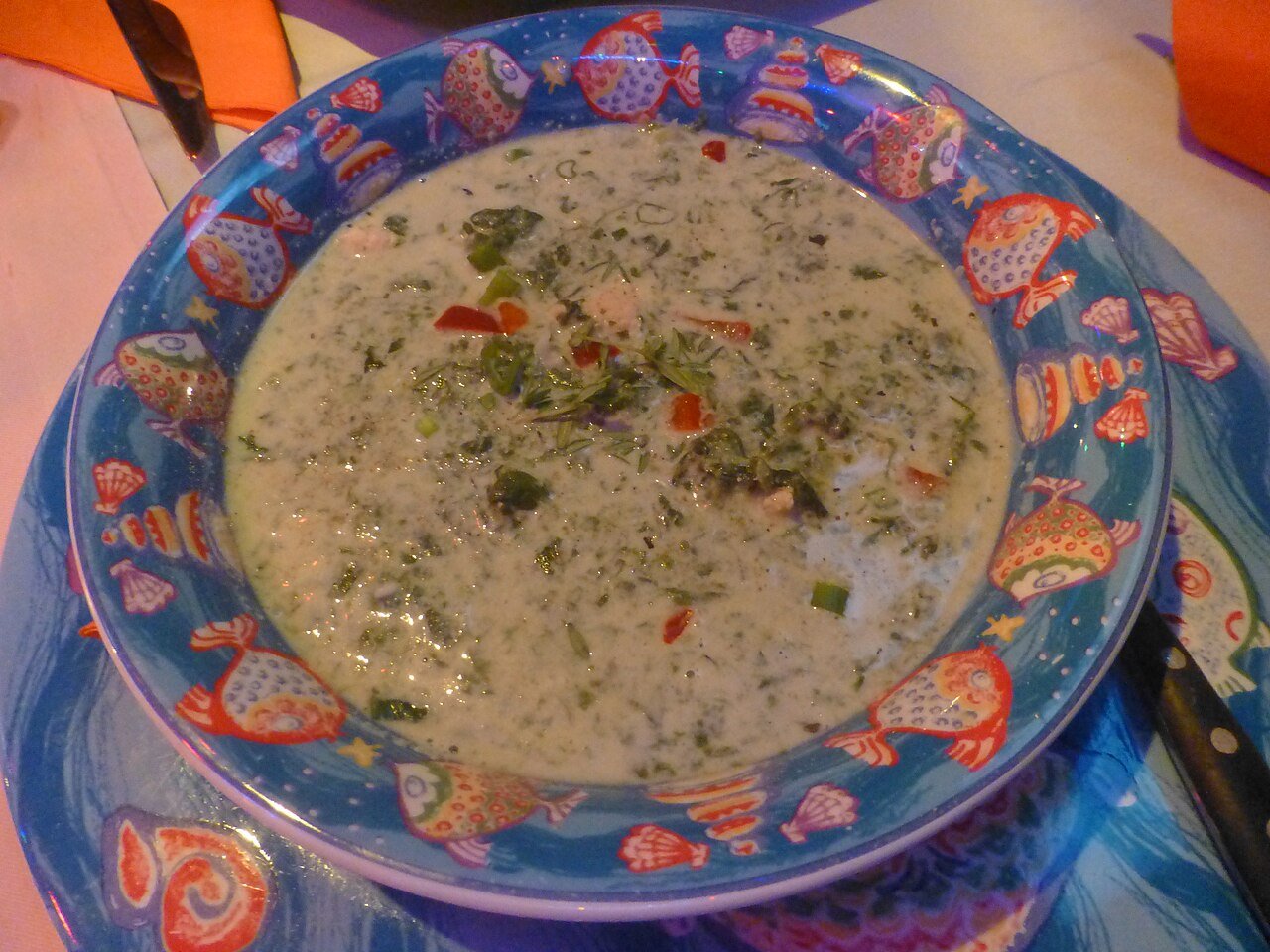 Representative photograph of Callaloo with Coconut. The photograph shows a soupier callaloo preparation; this recipe reduces the coconut liquid around chopped greens.