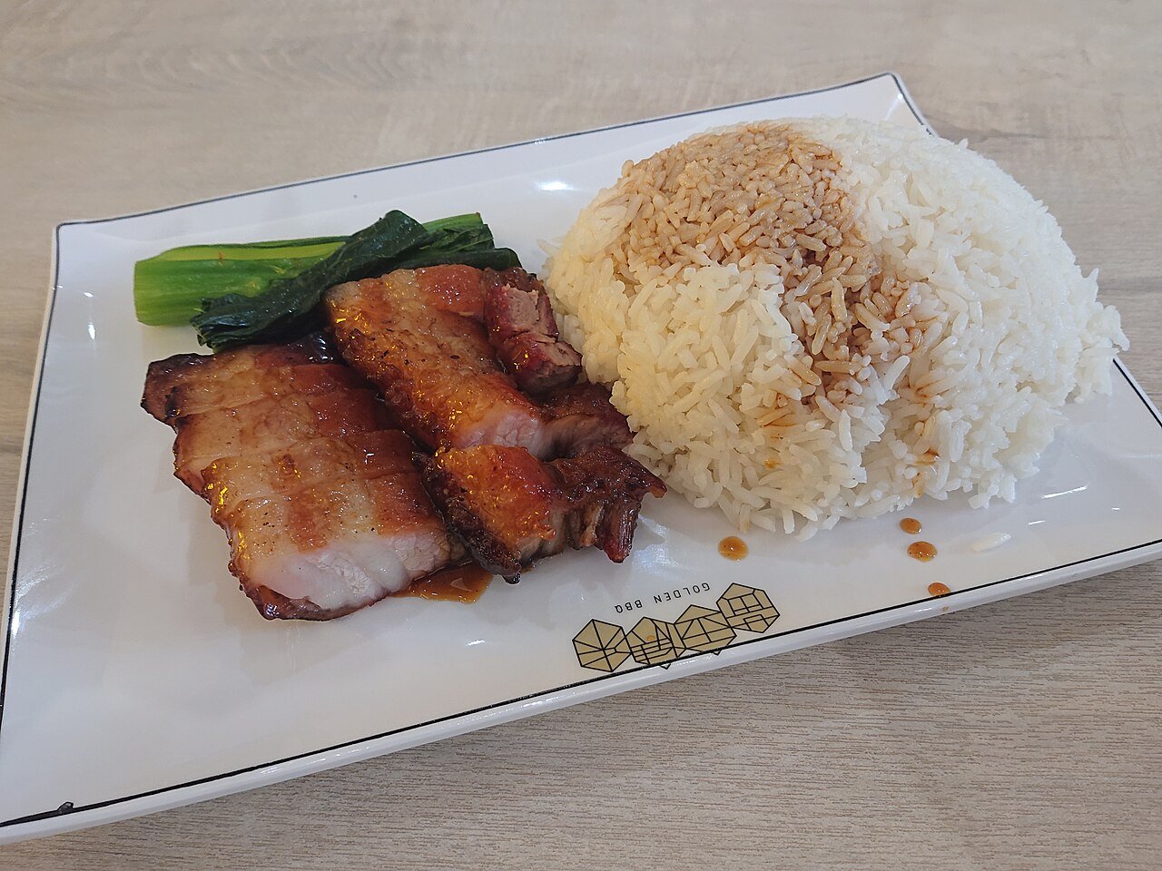 Representative photograph of Char Siu Pork. The photograph uses pork belly with rice and greens; this recipe uses pork shoulder and omits the accompaniments.