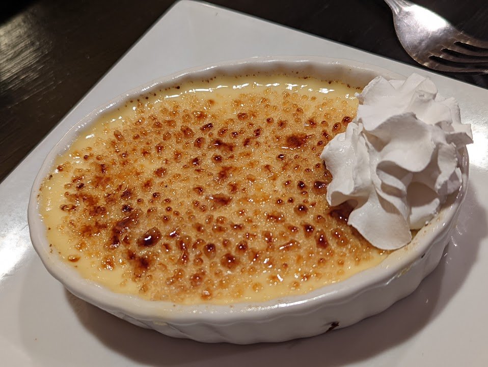 Representative photograph of Creme Brulee. The photograph includes whipped cream not included in this recipe.