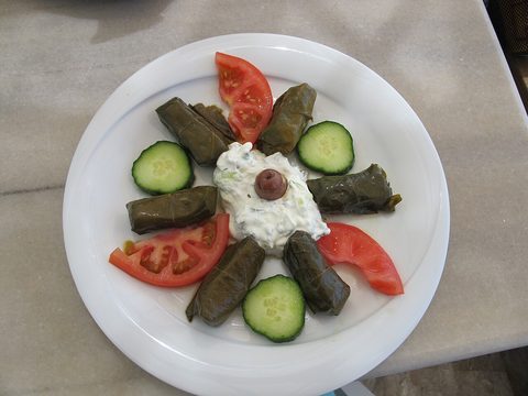 Representative photograph of Dolmades. The photograph includes yogurt and salad garnishes not included in this recipe.