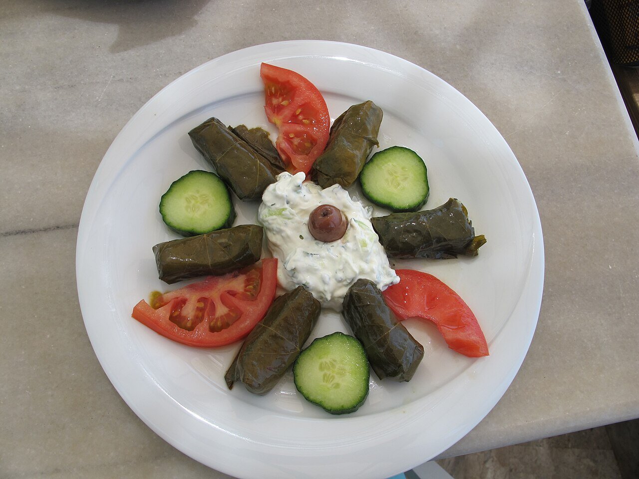 Representative photograph of Dolmades. The photograph includes yogurt and salad garnishes not included in this recipe.