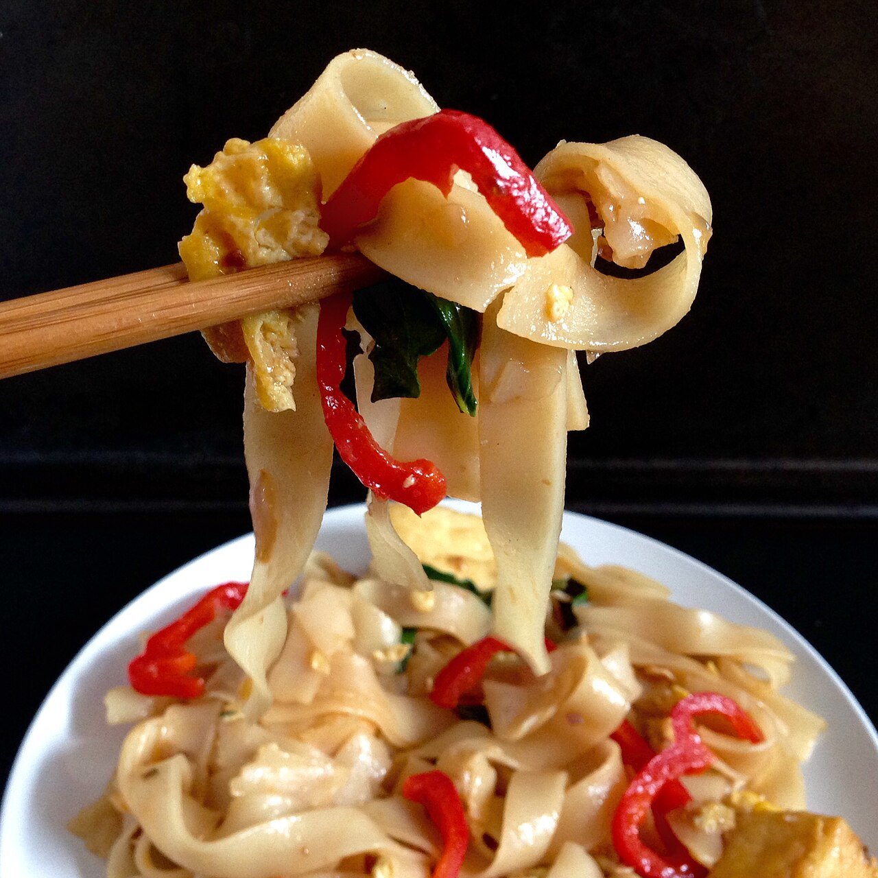 Representative photograph of Drunken Noodles. The photograph shows one lifted portion; the vegetables may differ from this recipe.