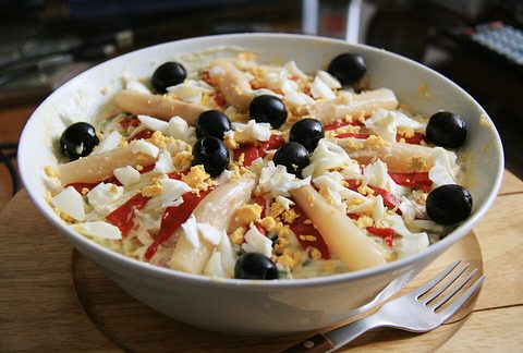 Representative photograph of Ensaladilla Rusa. The photograph includes olives and pepper garnish.