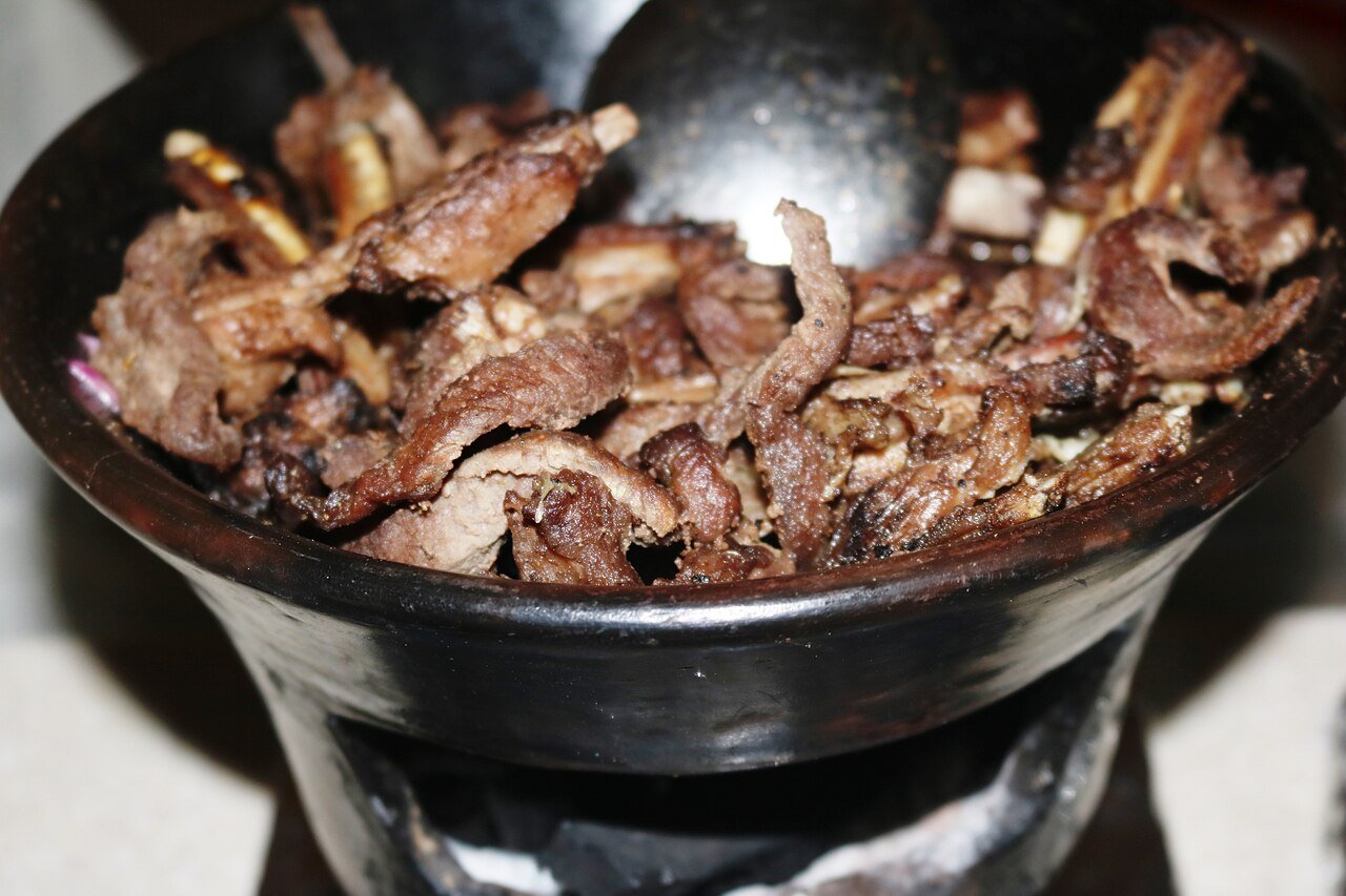Representative photograph of Ethiopian Beef Tibs. The photograph shows a sizzling serving with different accompaniments from this recipe.