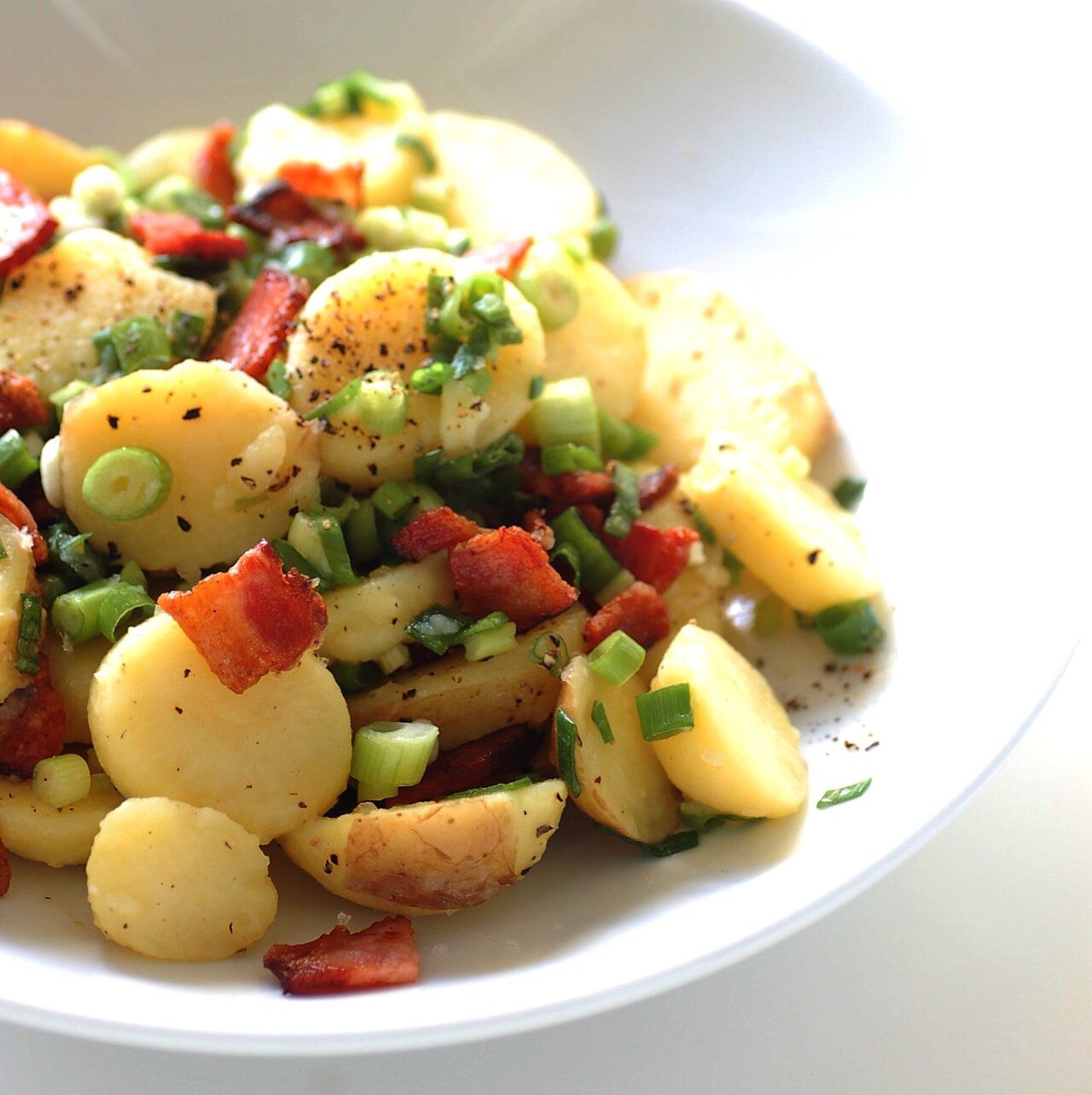 Representative photograph of German Potato Salad. The photograph includes additional vegetables beyond the onion and chives in this recipe.