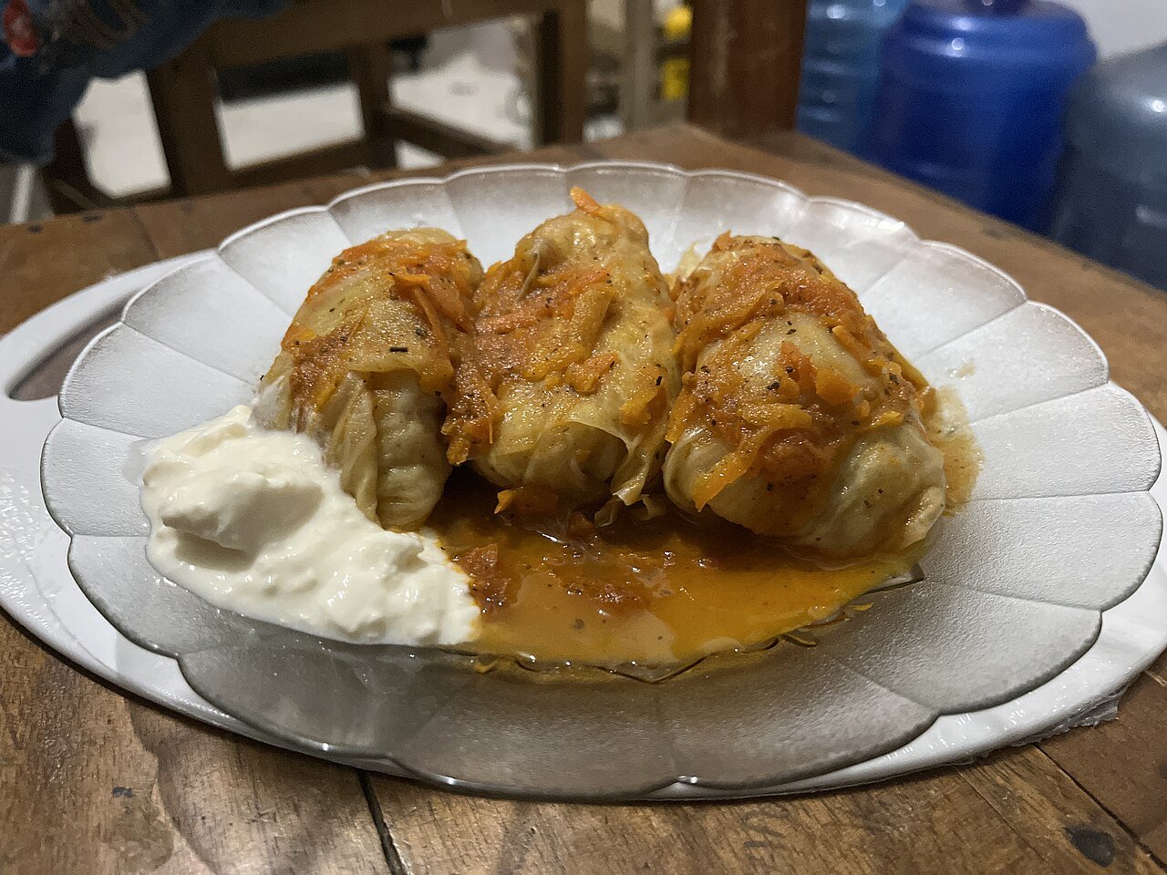 Representative photograph of Golubtsy. The photograph includes sour cream and a different sauce presentation from this recipe.