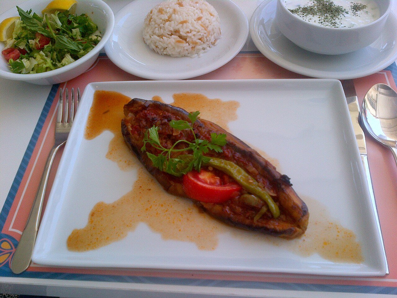Representative photograph of Karniyarik. The photograph includes side dishes not included in this recipe.