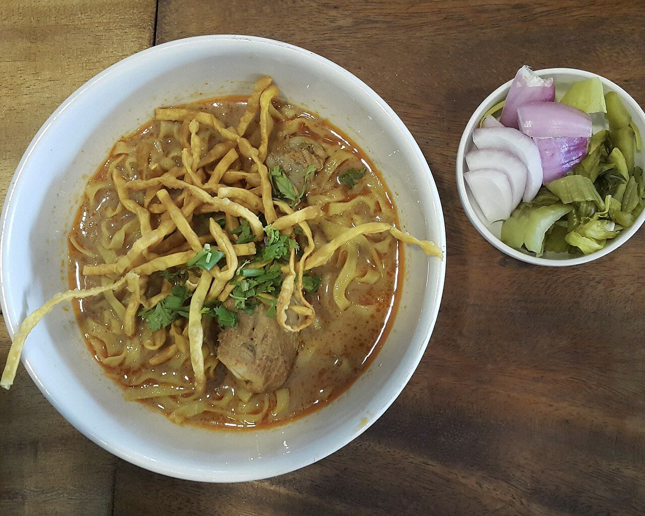 Representative photograph of Khao Soi. The photograph includes separate pickled vegetables and garnish not included in this recipe.