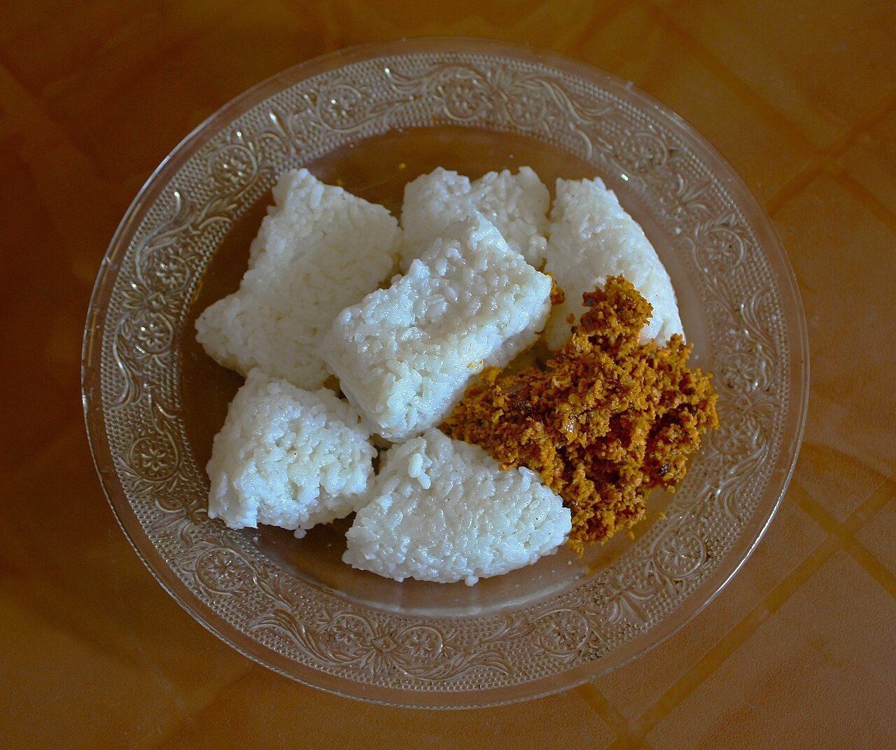 Representative photograph of Kiribath. The photograph includes sambol not included in this recipe.