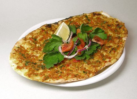 Representative photograph of Lahmacun. The photograph includes lemon and salad garnish not included in this recipe.