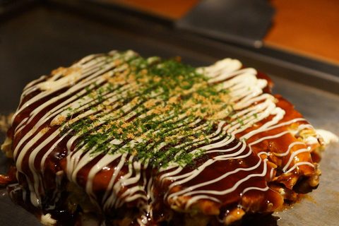 Representative photograph of Okonomiyaki. The photograph includes extra green garnish not included in the recipe.