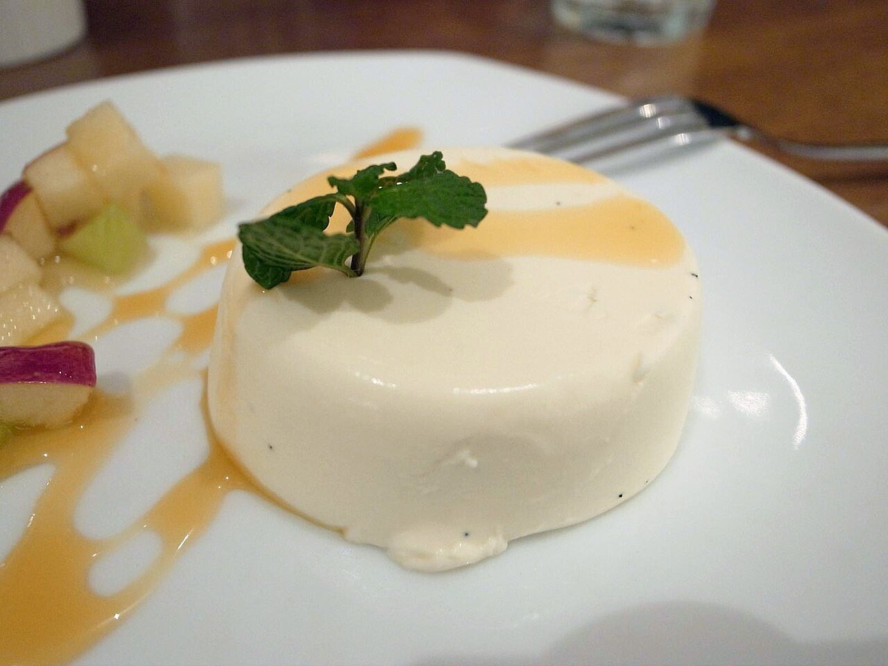 Representative photograph of Panna Cotta. The photograph includes fruit, sauce and mint garnish not included in this recipe.