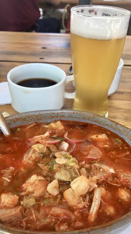 Representative photograph of Pozole Rojo. The photograph includes a drink not included in this recipe.