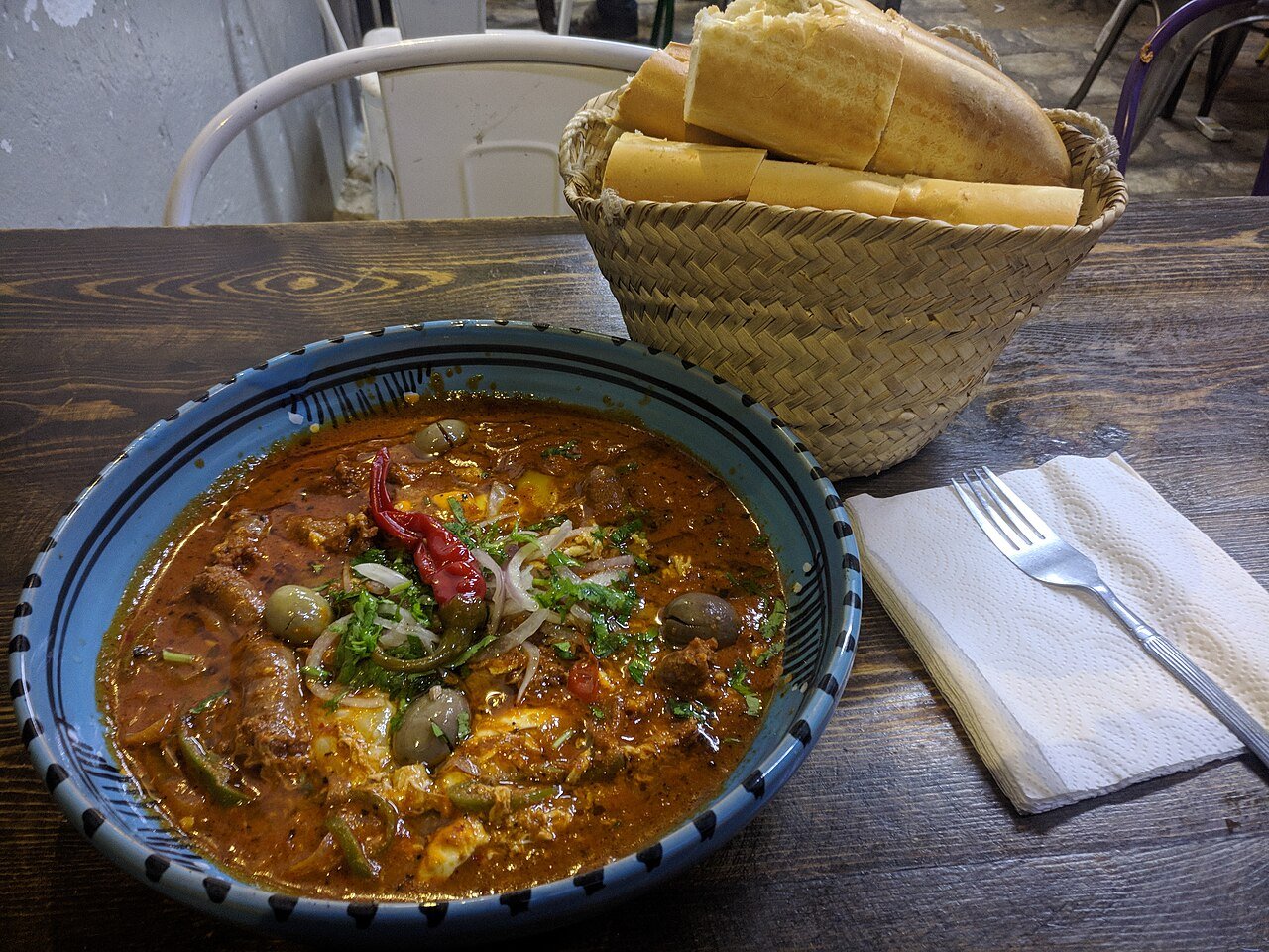 Representative photograph of Shakshuka with Merguez. The photograph includes bread and garnish not included in this recipe.