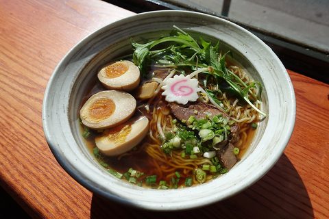 Representative photograph of Shoyu Ramen. The photograph includes egg, fish cake and other toppings that differ from the chicken toppings in this recipe.