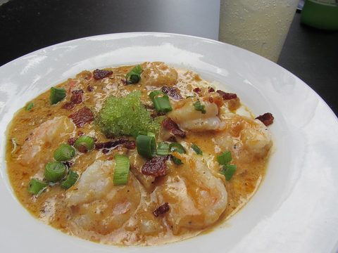 Representative photograph of Shrimp and Grits. The photograph includes extra garnish not included in this recipe.
