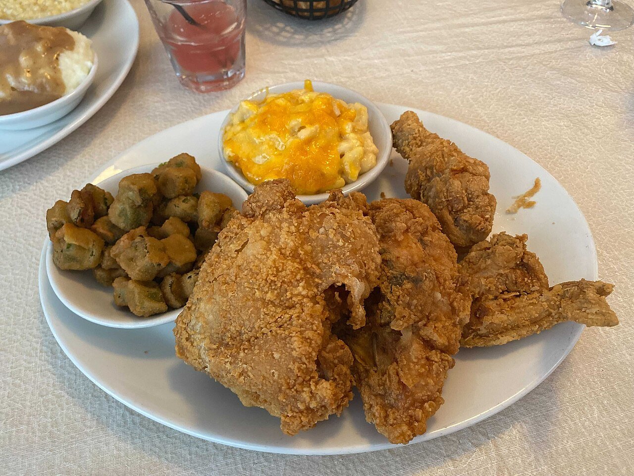 Representative photograph of Southern Fried Chicken. The photograph includes fried okra and macaroni cheese not included in this recipe.