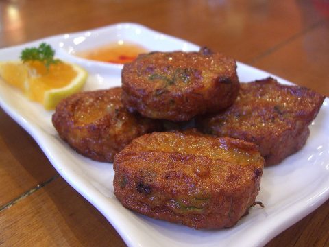 Representative photograph of Thai Fish Cakes. The photo includes dipping sauce and garnish not included in this recipe.