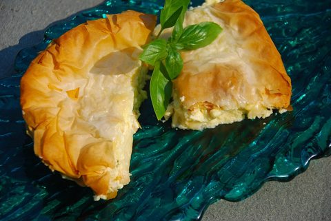 Representative photograph of Tiropita. The photograph shows a folded cheese pie; this recipe makes a layered tray pie.